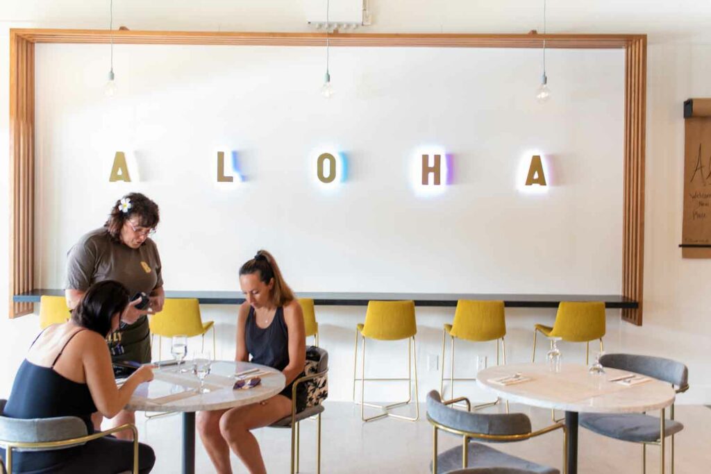 Welcoming Aloha Signage at Belly Restaurant